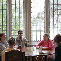 Students meet with a professor in the Lawyers Club Lounge.