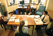 Professor Bridgette Carr, 02, director of the Human Trafficking Clinic, meets with students  and a client.